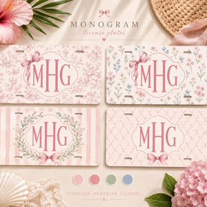 May include: Four rectangular license plates featuring the monogram MHG in pink lettering. Each plate displays a unique pattern: pink toile, colorful wildflowers, pink stripes with a floral wreath, and a pink quatrefoil design, all accented with bows.