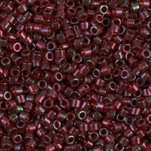 May include: A close-up view of a large quantity of small, round, red glass beads with an iridescent finish.