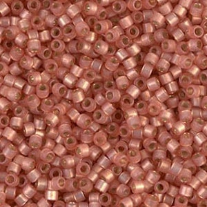 May include: A close-up view of a large quantity of small, round, pink seed beads. The beads have a subtle iridescent sheen.