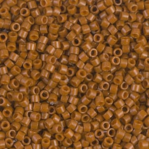 May include: A close-up view of a large quantity of small, brown, round beads. The beads are all the same size and shape, and they are arranged in a random pattern.