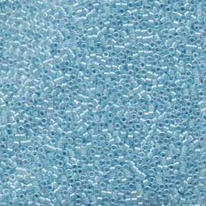 May include: A close-up view of a large quantity of small, light blue seed beads. The beads are round and have a slightly iridescent finish.