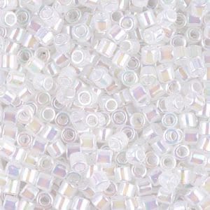 May include: A close-up of a pile of small, white, iridescent glass beads. The beads are square-shaped with a hole in the center.