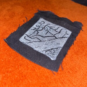 Toppa artigianale con stampa linoleografica in bianco e nero raffigurante un paesaggio montano – Accessorio Punk (7,6 x 7,6 cm)