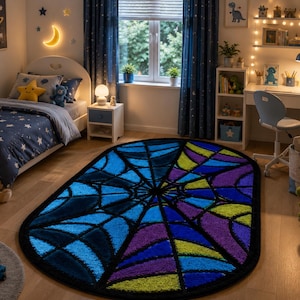 May include: An oval-shaped area rug featuring a prominent black spider web pattern against a vibrant background of blue, purple, and lime green segments. The rug has a thick black border and a textured surface, creating a bold graphic design.
