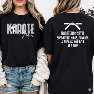 May include: Black t-shirt with white text that reads "Karate Mom" on the front and a karate belt graphic with text on the back. The back text says "Karate Mom Style Supporting Kicks, Punches & Dreams, One Belt At A Time."