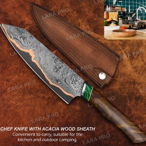 May include: A chef knife with a patterned blade and wooden handle, accompanied by a brown leather sheath. The blade has a unique design with copper accents. The text on the image says "CHEF KNIFE WITH ACACIA WOOD SHEATH".