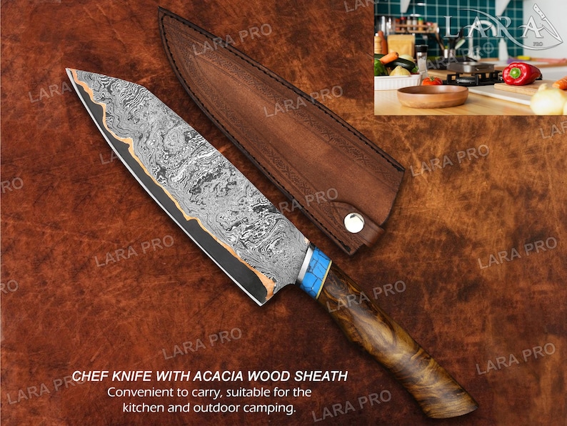 May include: Chef knife with acacia wood handle and sheath. The blade has a unique patterned design with a blue and gold accent on the handle. The knife is designed for kitchen and outdoor use.