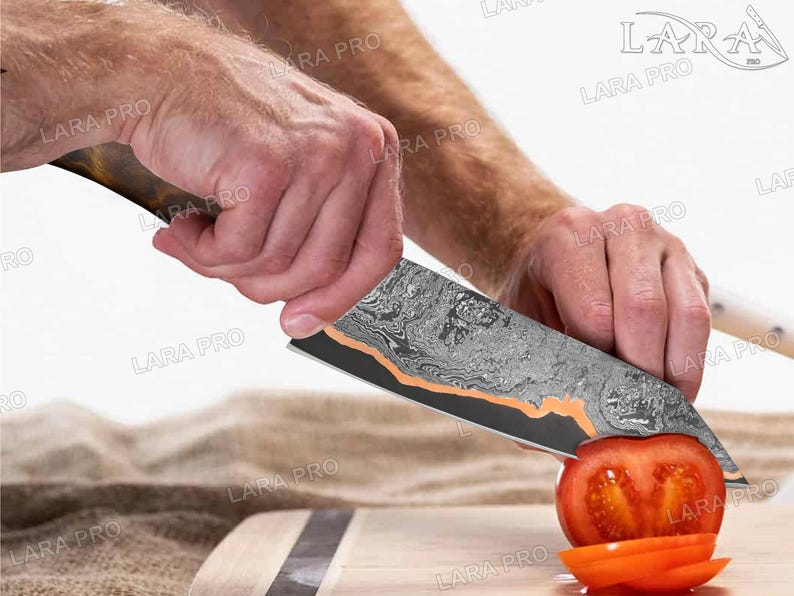 May include: A Damascus steel chef's knife with a wooden handle is slicing a red tomato on a wooden cutting board. The knife blade has a unique pattern with copper accents. The tomato is cut into slices.