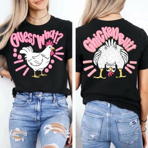 May include: Black t-shirt with a pink and white chicken graphic. The front of the shirt says "Guess What?" with a drawing of a chicken. The back of the shirt says "Chicken Butt" with a drawing of a chicken.