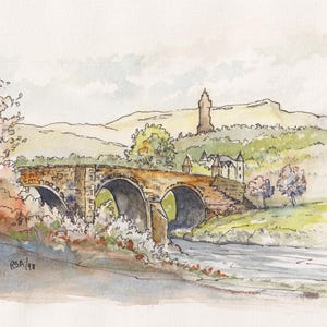 May include: Watercolor painting of a stone bridge with three arches over a river. The bridge is brown and tan, with a castle and monument in the background. The painting is signed "RSA/98".