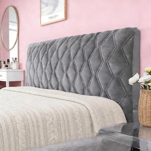 May include: A rectangular headboard upholstered in grey velvet fabric featuring a prominent diamond-stitched tufted pattern. The headboard has a thick, padded construction with clean, straight edges and a smooth, soft-touch surface texture.