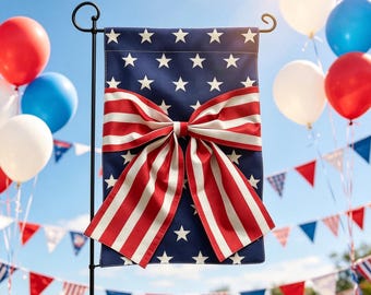 May include: A patriotic garden flag with a navy blue background and white stars. A large red and white striped bow is centered on the flag. Red, white, and blue balloons and bunting decorate the background.