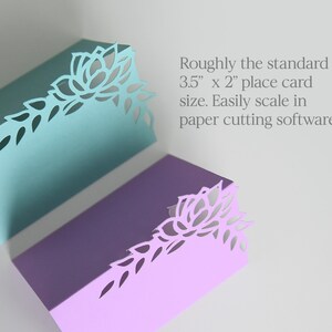 May include: Two place cards with a floral design cut out of the top right corner. The cards are 3.5 inches by 2 inches and are available in teal and lavender.