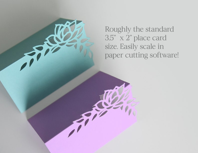 May include: Two place cards with a floral design cut out of the top right corner. The cards are 3.5 inches by 2 inches and are available in teal and lavender.