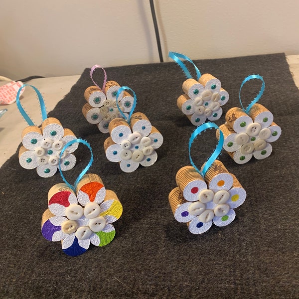 Wine cork, wool, paint and pearls flower ornaments.  Handmade for gift giving or as wine bottle bling