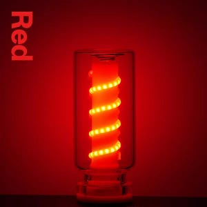 Puede incluir: Una lámpara cilíndrica de cristal con una luz roja que emana de un pilar central. Una tira LED de color amarillo brillante está envuelta en espiral alrededor del pilar. La palabra Red está impresa en la esquina superior izquierda en negrita.