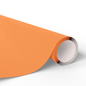May include: A roll of orange paper with a white interior and a silver edge. The paper is a solid, vibrant orange color and is partially unrolled, revealing the white interior and silver edge.