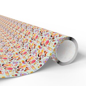 May include: A roll of wrapping paper with a repeating pattern of cartoon characters and objects in shades of pink, orange, purple, and brown on a light blue background. The paper is rolled up, revealing the metallic silver interior of the roll.