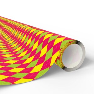 May include: A roll of wrapping paper featuring a repeating argyle pattern in vibrant shades of hot pink, bright yellow, and lime green. The diamond-shaped design covers the entire surface of the paper, which is wound around a central core.