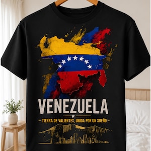 May include: A black short-sleeve t-shirt featuring a distressed map of Venezuela filled with the national flag colors of yellow, blue, and red with white stars. Below the map, the text reads VENEZUELA, TIERRA DE VALIENTES, UNIDA POR UN SUEÑO.
