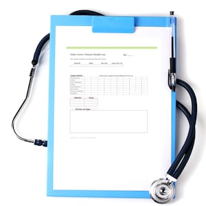 May include: A blue clipboard with a health log, a black pen, and a stethoscope. The health log is titled "Daily Graves' Disease Health Log" and includes sections for symptoms, medication, and daily notes.
