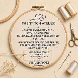 May include: A wooden embroidery hoop containing fabric with dark blue text reading THE STITCH ATELIER, DIGITAL EMBROIDERY FILE, and a list of file formats. Includes two spools of thread, vintage-style scissors, and a needle.