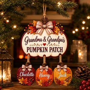 May include: A hanging pumpkin-shaped ornament featuring the text Grandma & Grandpa's PUMPKIN PATCH with three smaller pumpkin ornaments dangling below, each labeled with the names Charlotte, Henry, and Jack, decorated with bows and autumn leaves.