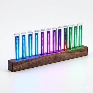 May include: A wooden base holds ten clear glass tubes, each illuminated with a vertical line of colorful LED lights. The lights transition from blue to purple, red, and green. The base is made of dark wood.