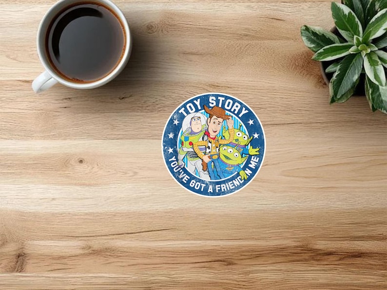 May include: A circular sticker featuring the Toy Story characters Woody, Buzz Lightyear, and two green aliens. The design includes the text TOY STORY and YOU'VE GOT A FRIEND IN ME in white lettering against a blue background with white stars.