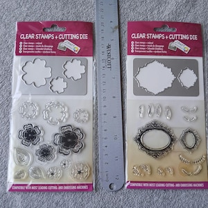 May include: Two packages of clear stamps and cutting dies. One package features flower and leaf designs, the other has ornate frames and decorative elements. The packages include the text "CLEAR STAMPS + CUTTING DIE" and are compatible with most leading cutting and embossing machines.