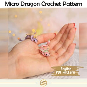 May include: The image displays two miniature crochet dragons in shades of purple and pink, with delicate wings and details. The text at the top reads "Micro Dragon Crochet Pattern" and the text at the bottom reads "English PDF Pattern".