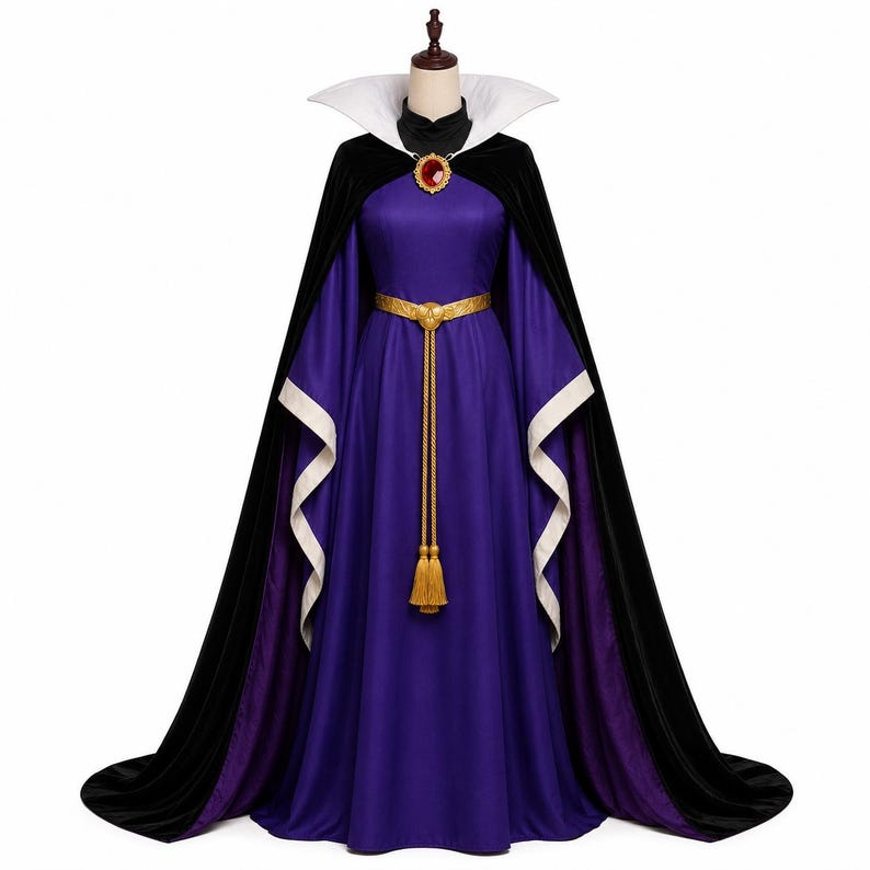 May include: A floor-length purple gown with long, wide sleeves featuring white cuffs. The dress includes a black velvet cape with a high white collar, a gold-toned belt with a long tassel, and a decorative brooch with a large red stone at the neck.
