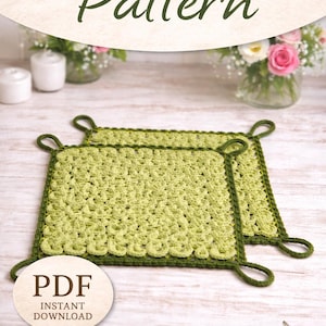 May include: Two light green crochet potholders with dark green borders and loop handles. The image includes the text "CROCHET Pattern" and "PDF Instant Download Digital Download". The potholders are on a light wood surface.