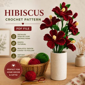 May include: A crochet pattern for hibiscus flowers, featuring text HIBISCUS CROCHET PATTERN PDF FILE. The image displays dark red crocheted hibiscus flowers with yellow centers in a cylindrical vase, alongside a basket of yarn balls and a hook.
