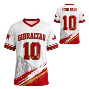 May include: A white sports jersey featuring the word GIBRALTAR in red letters across the chest, the number 10 in red with gold outlines, a graphic of the Rock of Gibraltar, red star accents, and the Gibraltar flag on the sleeve and back.