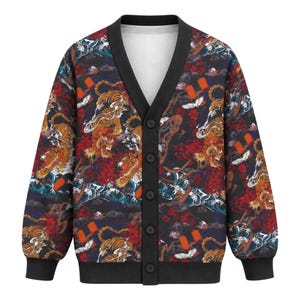 May include: A long-sleeve button-up cardigan featuring a black base with a repeating pattern of orange tigers, red flowers, white clouds, and blue wave motifs. The garment has a solid black V-neck collar, black cuffs, and a black hem with five buttons.