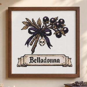 May include: A framed cross-stitch embroidery featuring a cluster of dark purple belladonna berries tied with a dark purple ribbon and a small skull charm. Below the botanical illustration, a scroll banner displays the text Belladonna in black.