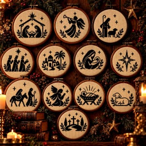 May include: A collection of eleven circular wooden embroidery hoops featuring black cross-stitch designs on beige fabric. The motifs depict various nativity scenes, including the holy family, angels, shepherds, wise men, and a star, all framed in wood.