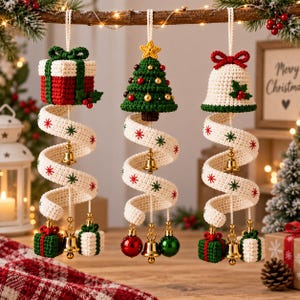 May include: Three hanging Christmas ornaments featuring a crocheted gift box, a Christmas tree, and a bell. Each ornament has a spiral white ribbon with red and green star patterns, gold bells, and small decorative items hanging at the bottom.