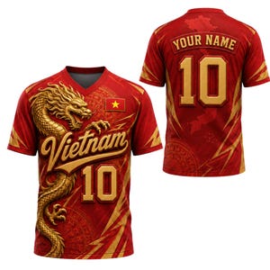 May include: A red V-neck t-shirt featuring a gold dragon graphic, the text Vietnam, the number 10, and a small Vietnamese flag. The back displays the text YOUR NAME above the number 10, with a subtle map outline and gold lightning bolt accents.