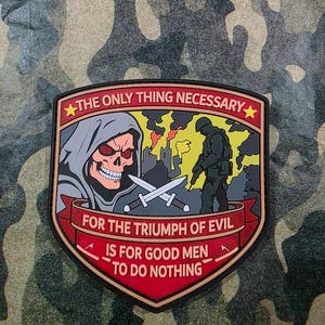 May include: A shield-shaped patch with a red border and a camouflage background. The patch features a skull in a gray hood, crossed swords, and a soldier. Text reads: "THE ONLY THING NECESSARY FOR THE TRIUMPH OF EVIL IS FOR GOOD MEN TO DO NOTHING."