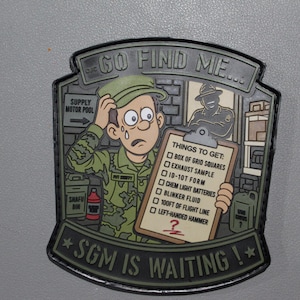 May include: A tactical morale patch featuring a cartoon soldier in camouflage uniform looking confused while holding a clipboard with the text GO FIND ME and THINGS TO GET, listing items like box of grid squares and left-handed hammer, with SGM IS WAITING at the bottom.