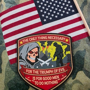 May include: A patch with the text "THE ONLY THING NECESSARY FOR THE TRIUMPH OF EVIL IS FOR GOOD MEN TO DO NOTHING" and a skull graphic, with an American flag in the background.