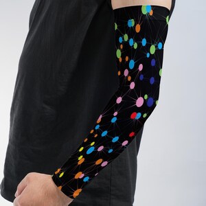 May include: A black arm sleeve featuring a vibrant network pattern of multicolored dots in shades of blue, green, orange, pink, and yellow, connected by thin white lines that create a geometric, constellation-like design across the fabric.