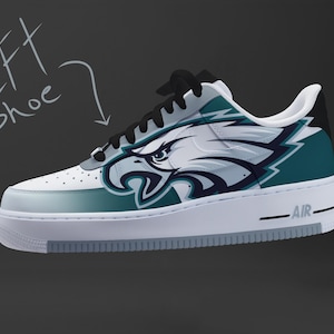 May include: White and teal Air Force 1 sneaker with a Philadelphia Eagles logo. The shoe features a white base with teal accents and a black swoosh. The word "AIR" is printed on the midsole.