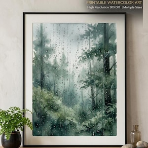 May include: A framed watercolour print depicting a forest scene seen through a rain-streaked window. The artwork uses shades of green and grey, with visible raindrops. Text at the top reads "INSTANT DIGITAL DOWNLOAD". Below the artwork, text reads "PRINTABLE WATERCOLOR ART High Resolution 300 DPI | Multiple Sizes".