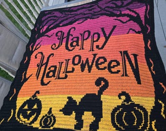 May include: A crocheted Halloween blanket featuring a gradient of colors from purple to orange to yellow. The blanket has the words "Happy Halloween" in black, along with silhouettes of a black cat and pumpkins.