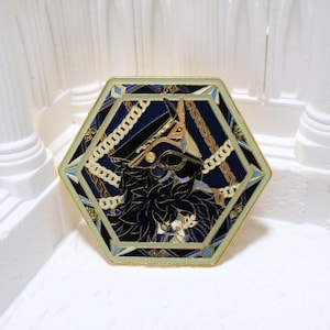 May include: Hexagonal enamel pin with a gold border and a dark blue background. The pin features a stylized illustration of a figure in a military-style hat and uniform, with gold chain accents. The design has a vintage aesthetic.