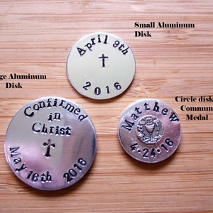 May include: Three silver aluminum discs with engraved text and a cross. The first disc says "Confirmed in Christ" with a cross and the date "May 16th 2016". The second disc says "April 9th 2016" with a cross. The third disc says "Matthew 4.24.16" with a communion chalice.