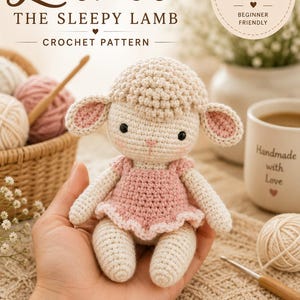May include: A crocheted lamb doll with a pink dress, part of a crochet pattern. The doll has a cream-colored body, head, and limbs, with pink accents on the ears and dress. The text "Lumi The Sleepy Lamb Crochet Pattern" is visible.